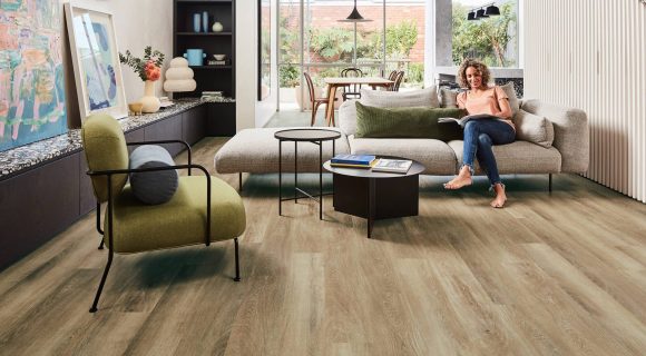 Woman sitting in Sofas, living room with vinyl flooring